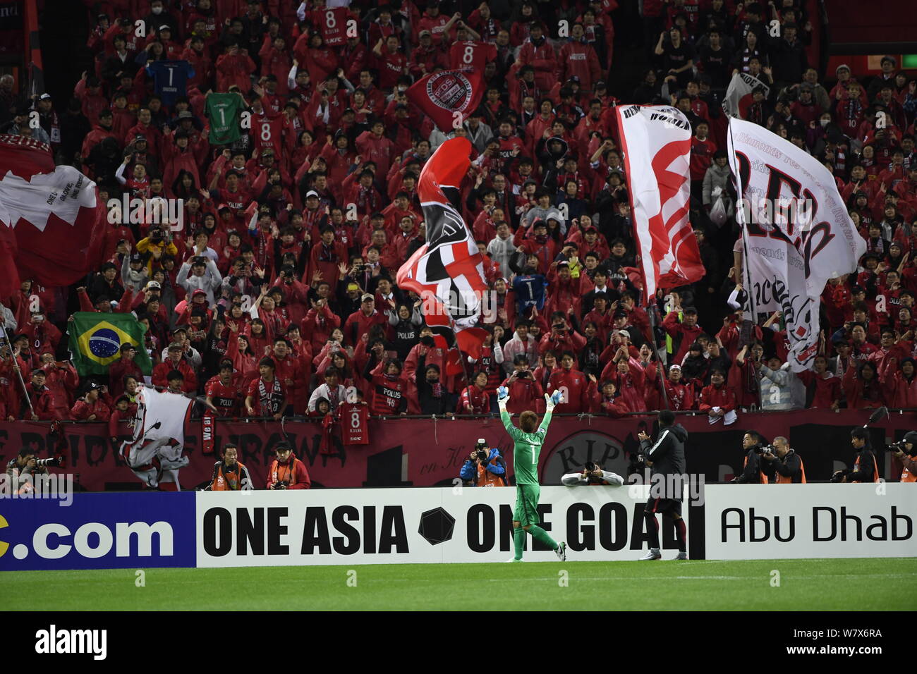 Shusaku Nishikawa of Japan's Urawa Red Diamonds waves to Japanese football fans after defeating China's Shanghai SIPG in their Group F match during th Stock Photo