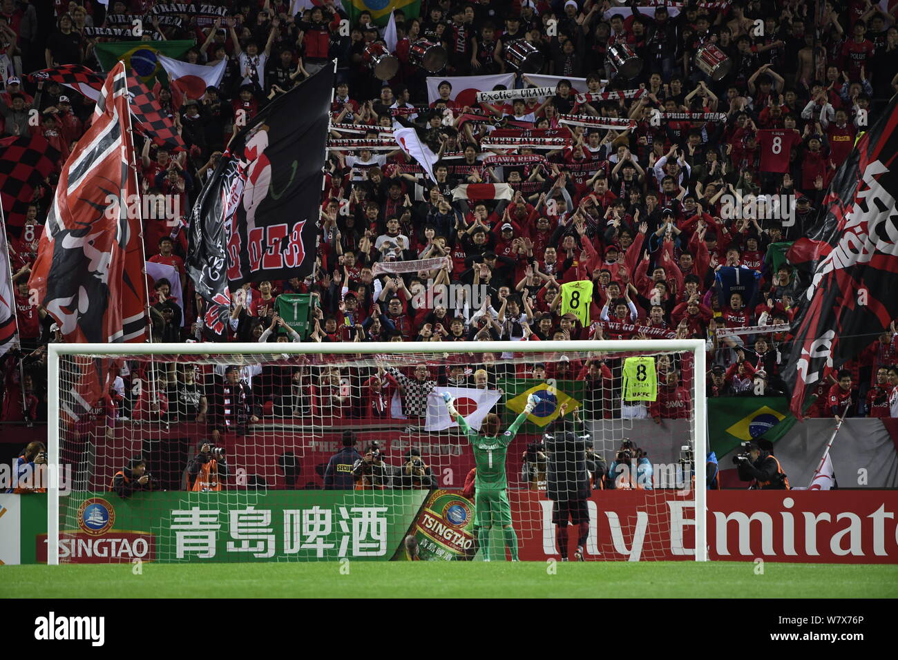 Shusaku Nishikawa of Japan's Urawa Red Diamonds waves to Japanese football fans after defeating China's Shanghai SIPG in their Group F match during th Stock Photo