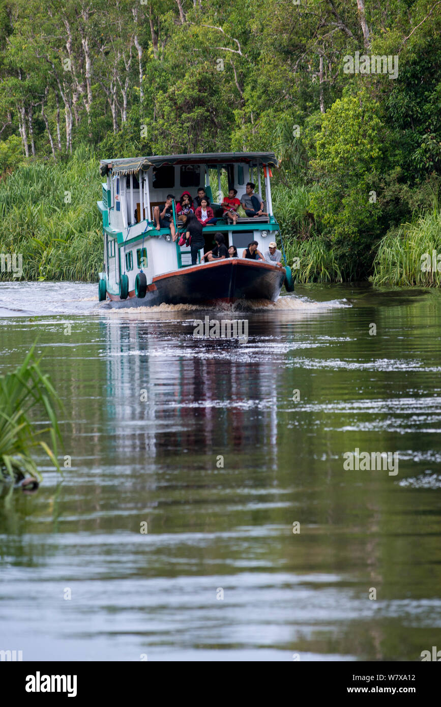 People on a boat on the River Kumai, Tanjung Puting National Park, Central Kalimantan, Borneo, Indonesia. Stock Photo