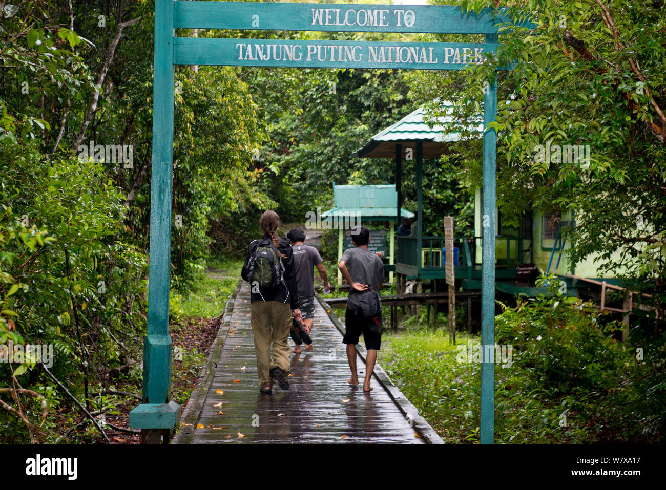 People walking through entrance to Tanjung Puting National Park, Central Kalimantan, Borneo, Indonesia. Stock Photo