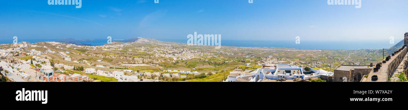 Top north view of the greek Santorini isle, from Pyrgos with aluminium cans for the easter fire festival at the roofs and on the wall of the castle. Stock Photo