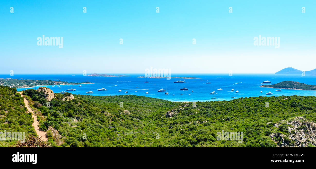 Panorama view on Costa Smeralda, beach Spiaggia di Liscia Ruja, island Isola Soffi, ships, yachts, boats, sailboats. Nearby Porto Cerve, Capriccioli. Stock Photo