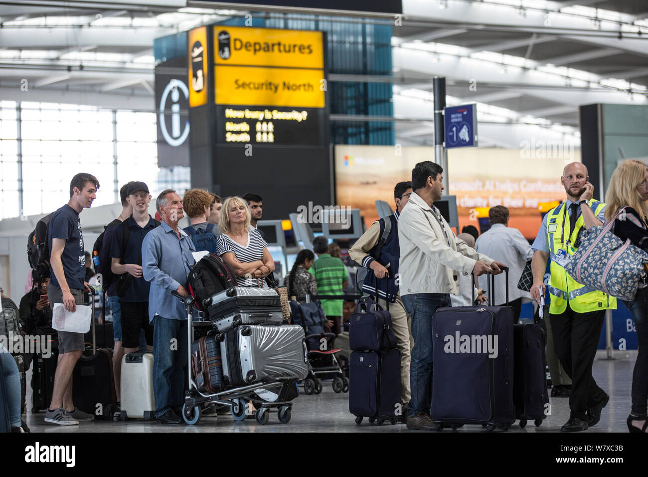Heathrow Terminal 5 British Airways passengers facing lengthy flight delays or cancellations due to technical issues, London, England, UK Stock Photo