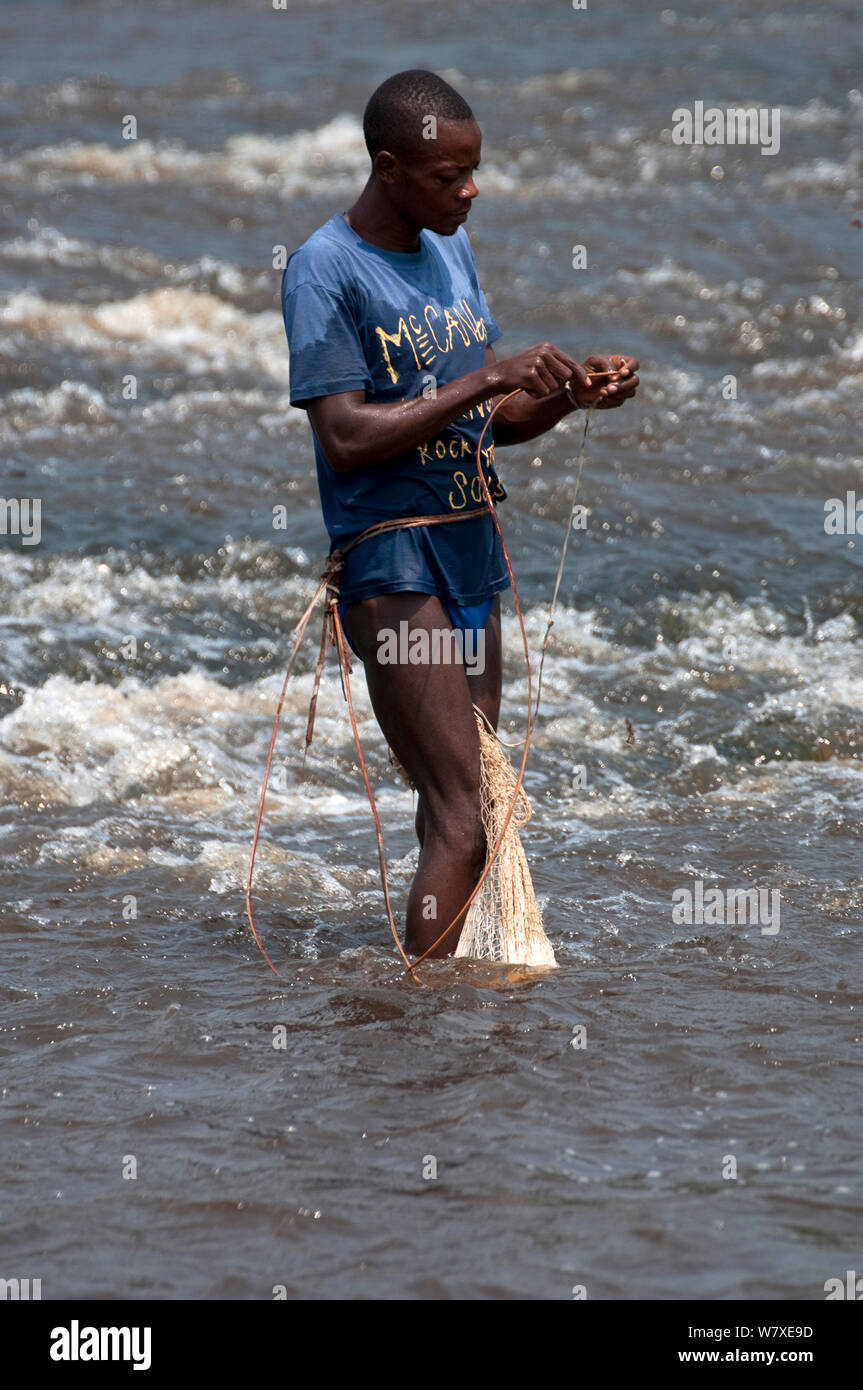 Fisherman with net on Ituri River, Bomili Village, Ituri forest, December 2011. Stock Photo