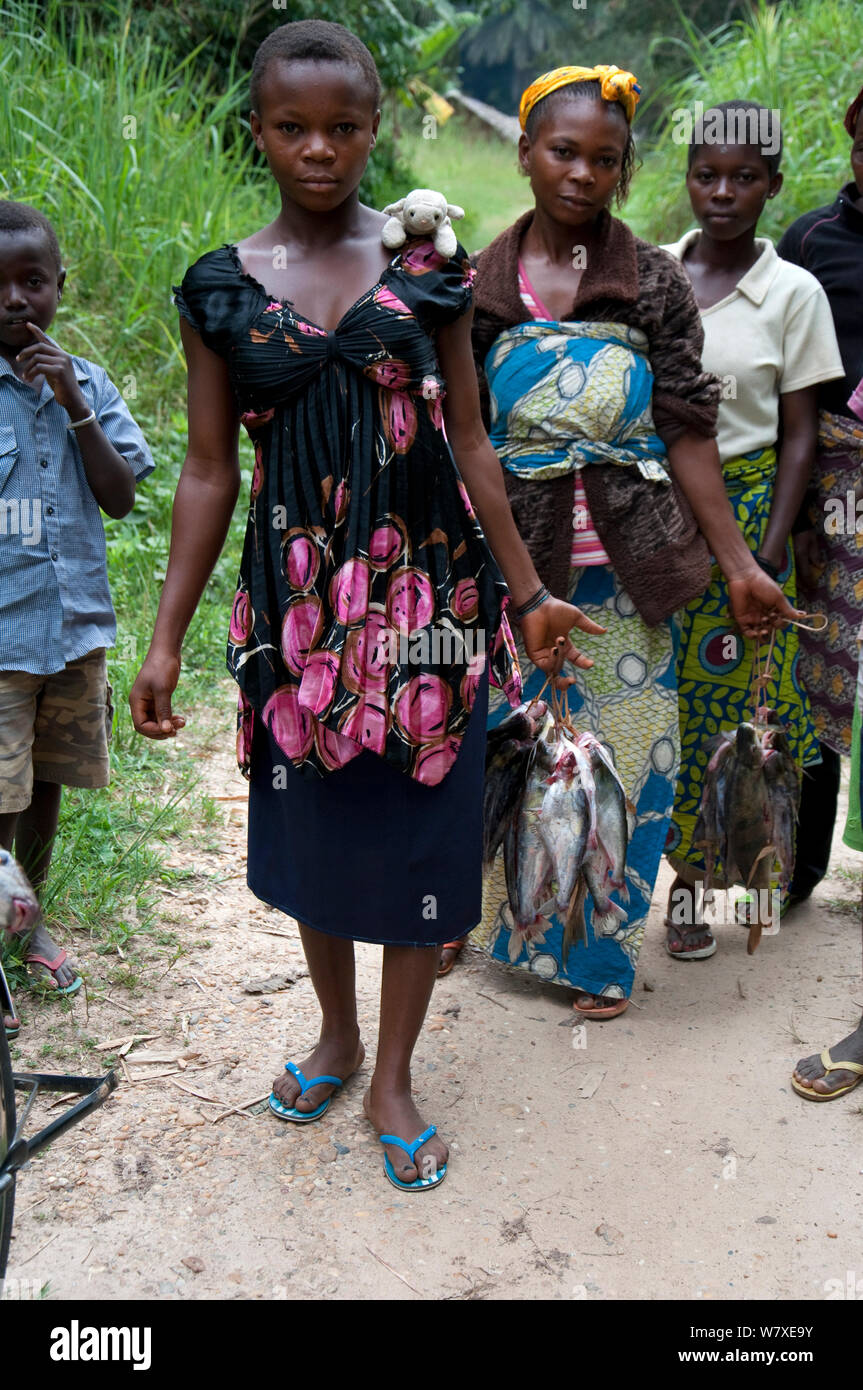 Women at Bomili village fish market, with Mongo people, Ituri rainforest, Democratic Republic of the Congo, December 2011. Stock Photo