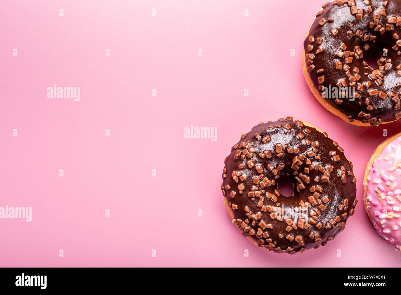 Colorful donuts on rose background Stock Photo