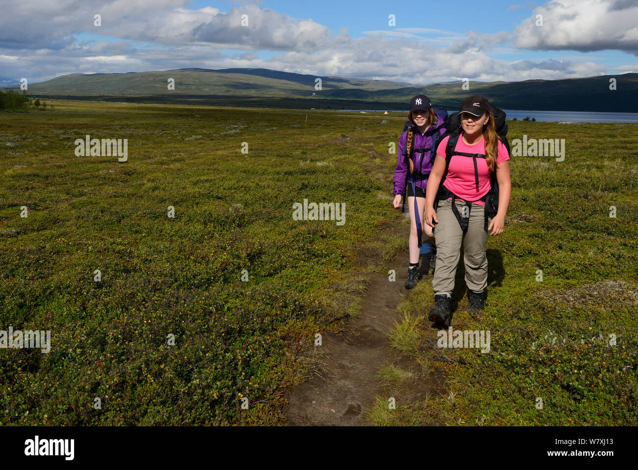 Teenage girls on family hiking trip on the Laponia Circuit, of the Padjelantaleden trail, Padjelanta National Park and Sarek National Park, Norrbotten, Lapland, Sweden. Model released Stock Photo