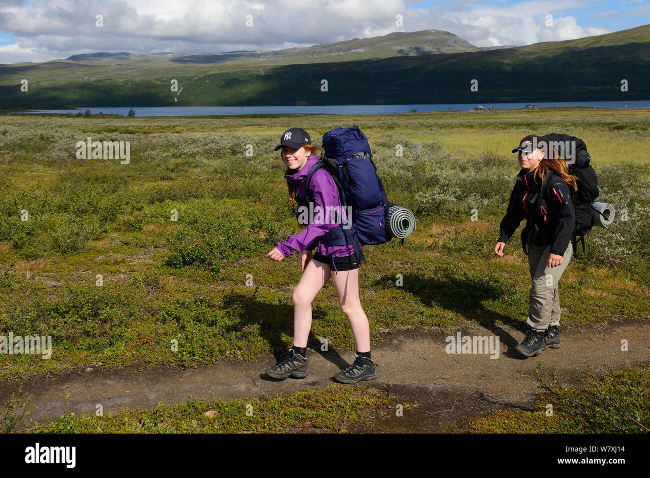 Teenage girls on family hiking trip on the Laponia Circuit, of the Padjelantaleden trail, Padjelanta National Park and Sarek National Park, Norrbotten, Lapland, Sweden. Model released Stock Photo