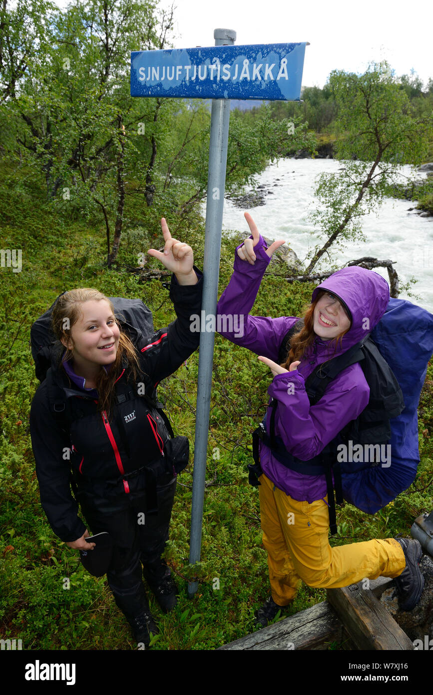 Two teenage girls pointing at sign post, on family hiking trip on the Laponia Circuit, along the Padjelantaleden trail, Padjelanta National Park and Sarek National Park, Norrbotten, Lapland, Sweden. Model released Stock Photo