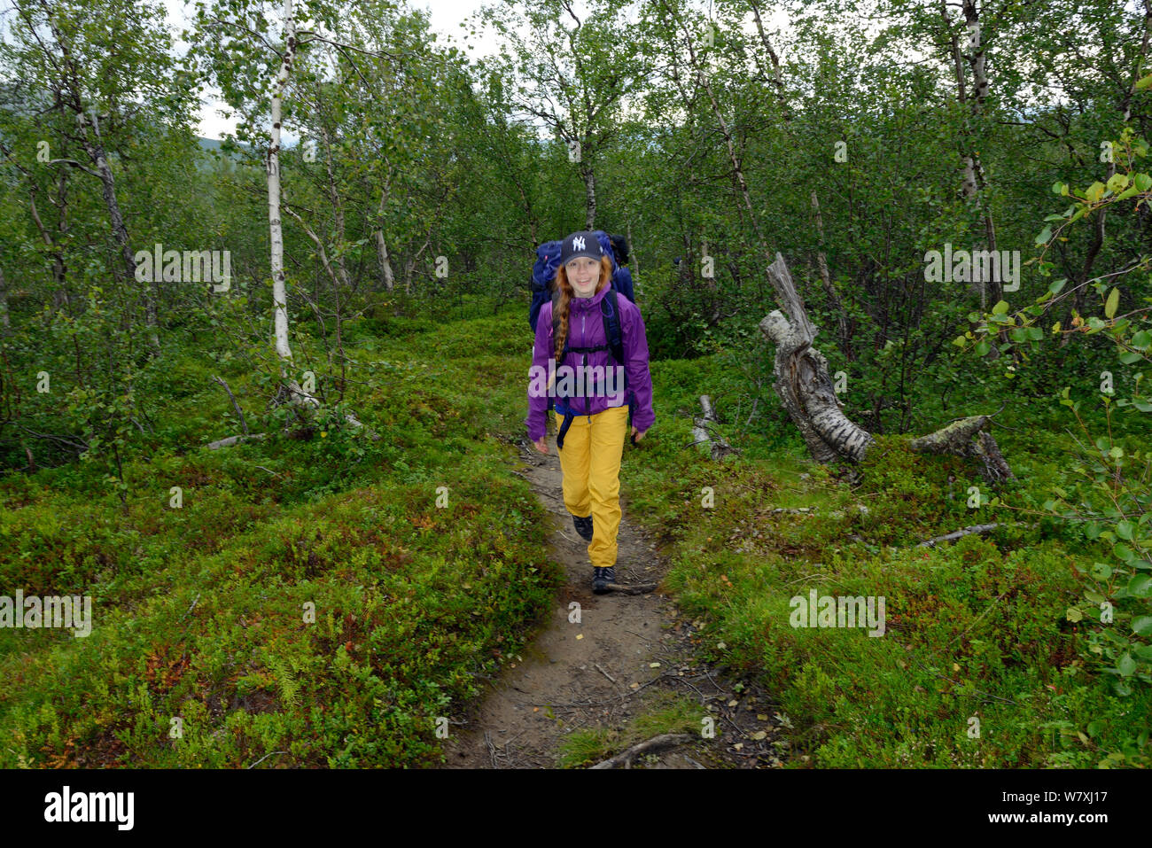 Teenage girl hiking along the Padjelantaleden trail, Padjelanta National Park and Sarek National Park, Norrbotten, Lapland, Sweden. Model released Stock Photo