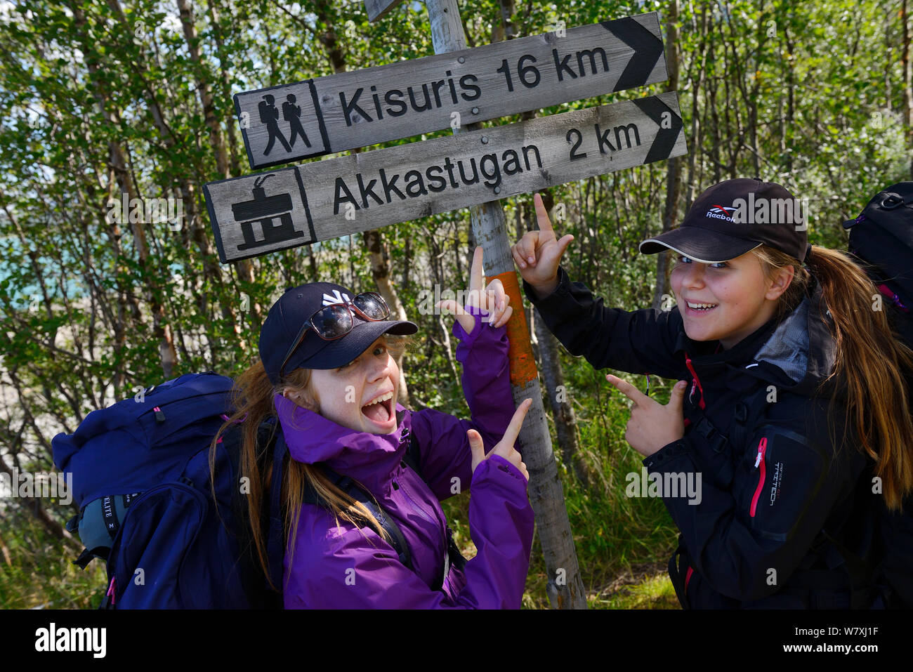 Two teenage girls standing by sign posts during hiking trip on the Laponia Circuit, along the Padjelantaleden trail, Padjelanta National Park, Norrbotten, Lapland, Sweden. Model released Stock Photo