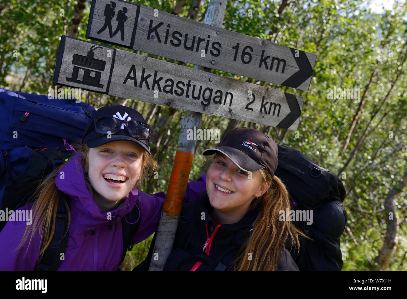 Two teenage girls standing by sign posts during hiking trip on the Laponia Circuit, along the Padjelantaleden trail, Padjelanta National Park, Norrbotten, Lapland, Sweden. Model released Stock Photo