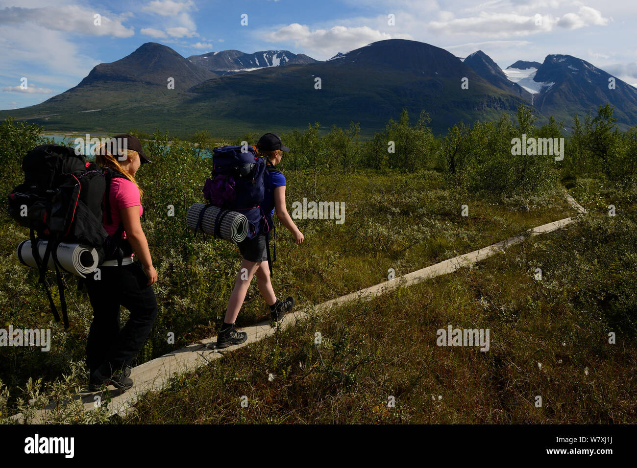 Two teenage girls on hiking trip on the Laponia Circuit, along the Padjelantaleden trail, Padjelanta National Park and Sarek National Park, Norrbotten, Lapland, Sweden. Model released Stock Photo