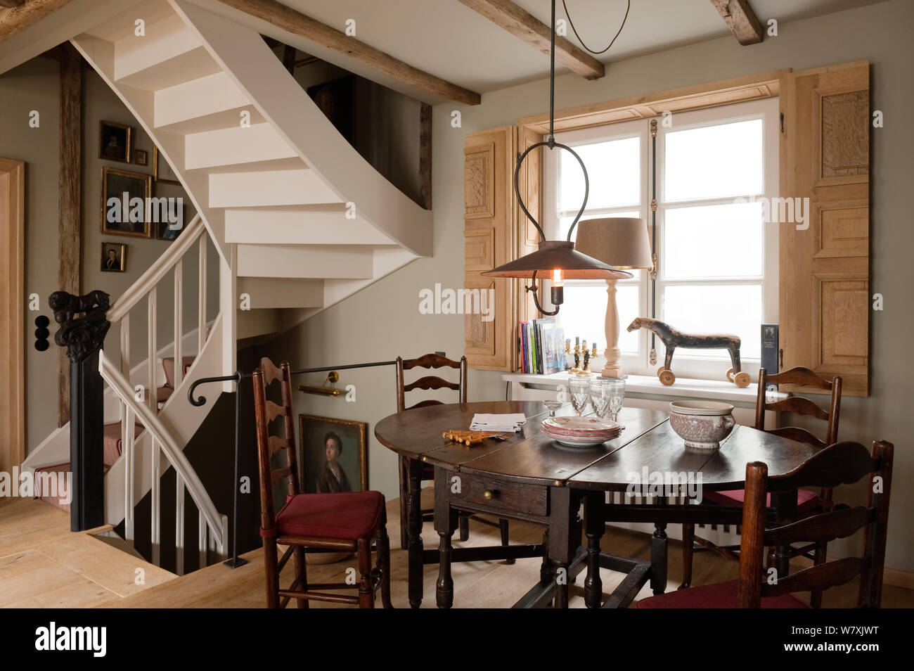 Victorian style dining room by spiral staircase Stock Photo