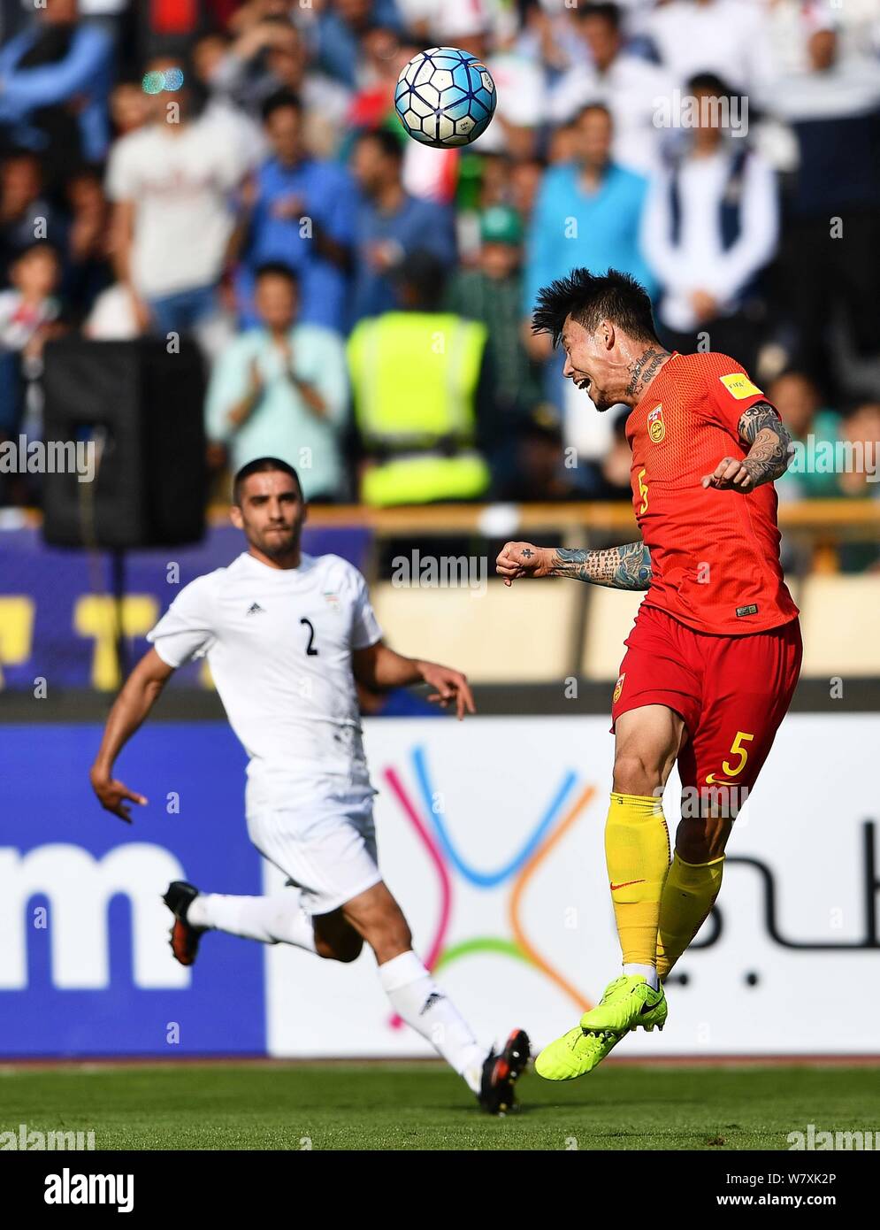 Milad Mohammadi of Iran, left, challenges Zhang Linpeng of China in their Group A Round 7 match during the FIFA World Cup 2018 Asian Qualifiers in Teh Stock Photo
