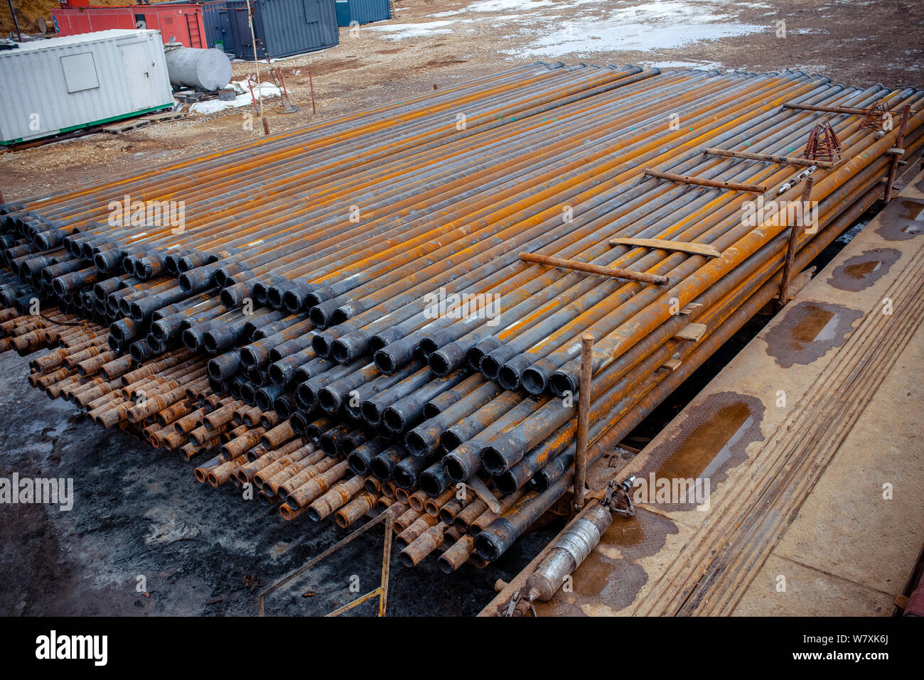 Drill pipe of oil drilling platforms. Stack of oil well casing bundles