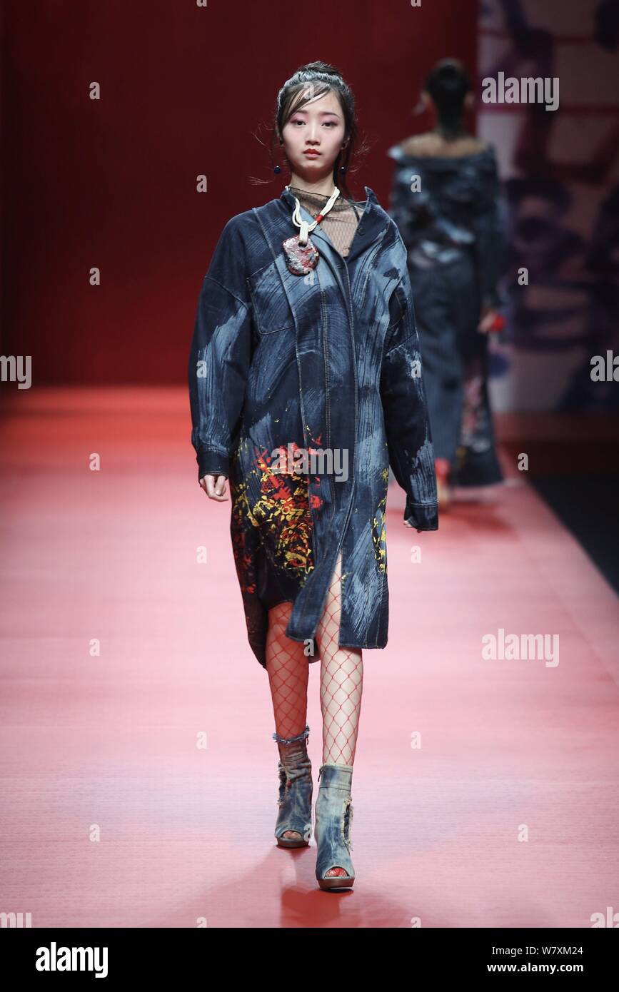 A model displays a new creation at the fashion show of CHENWEN Studio ...