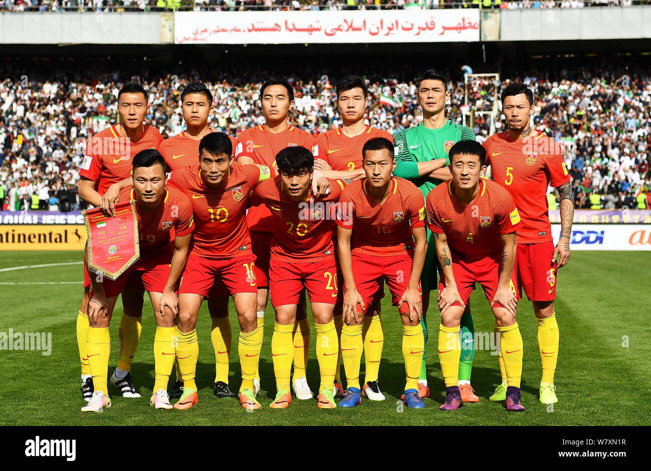 Players of the starting lineup of Chinese national football team pose before competing against