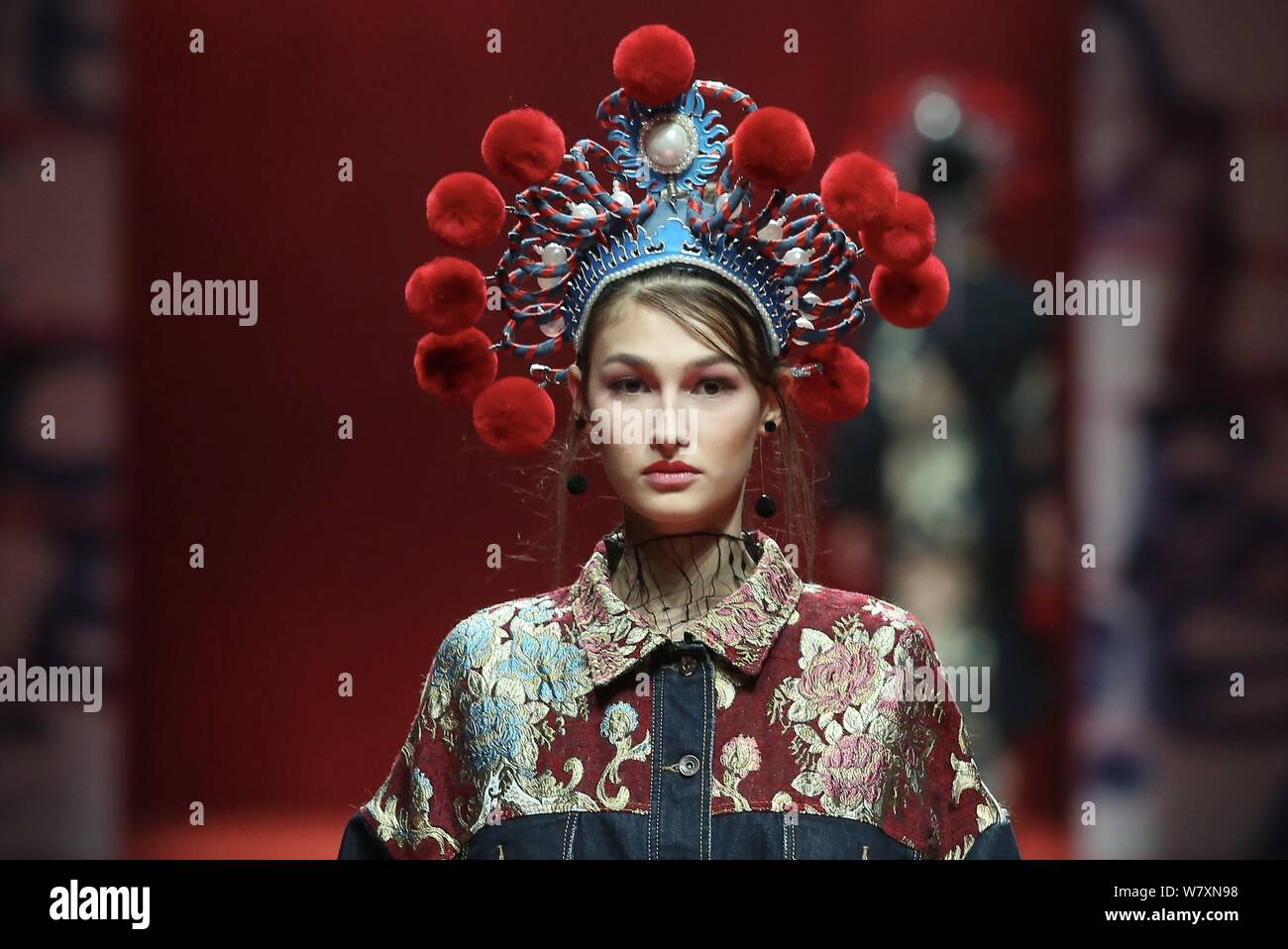 A model displays a new creation at the fashion show of CHENWEN Studio ...