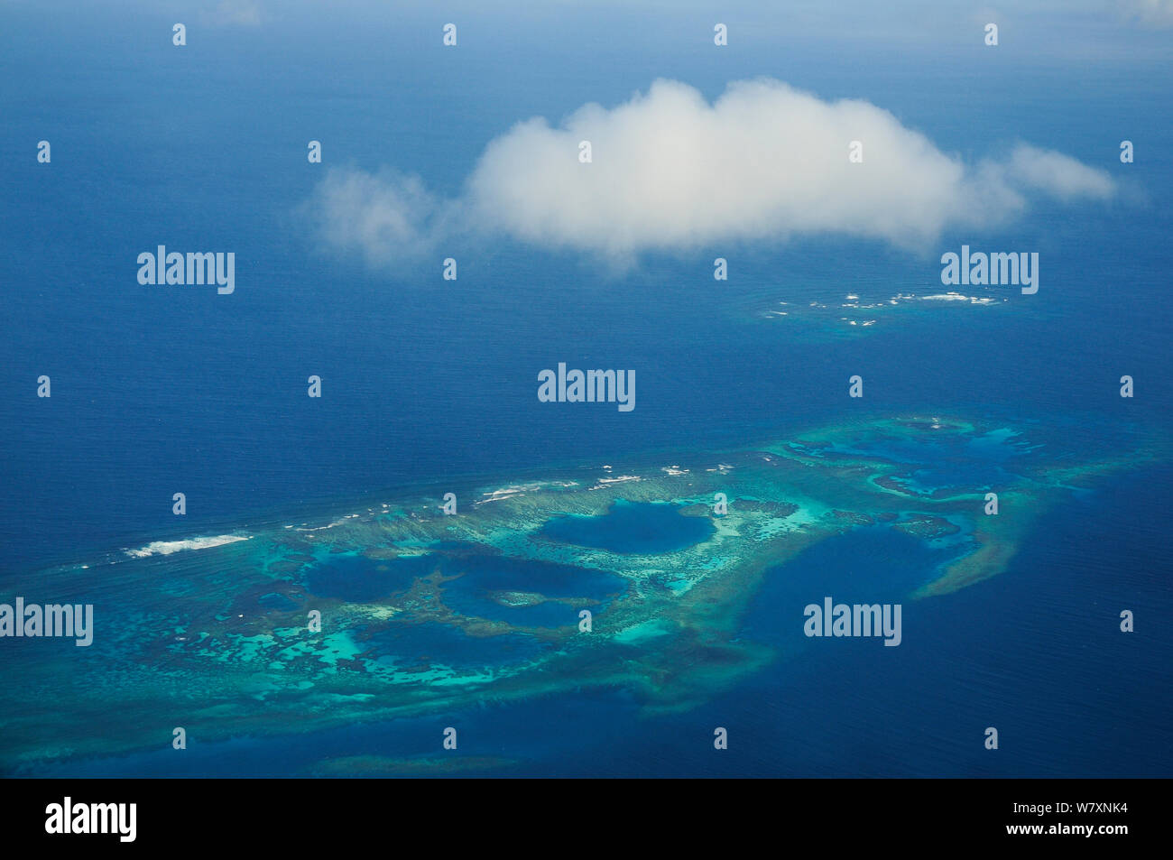 Aerial view of atolls with surrounding coral reefs, off the coast of New Caledonia, September 2008. Stock Photo