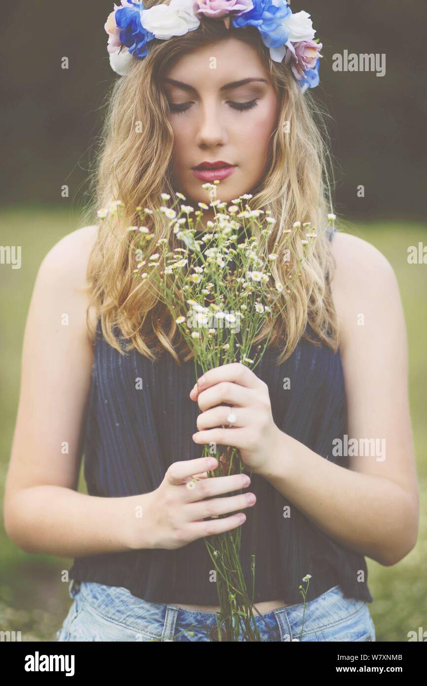 beautiful young woman holding flower Stock