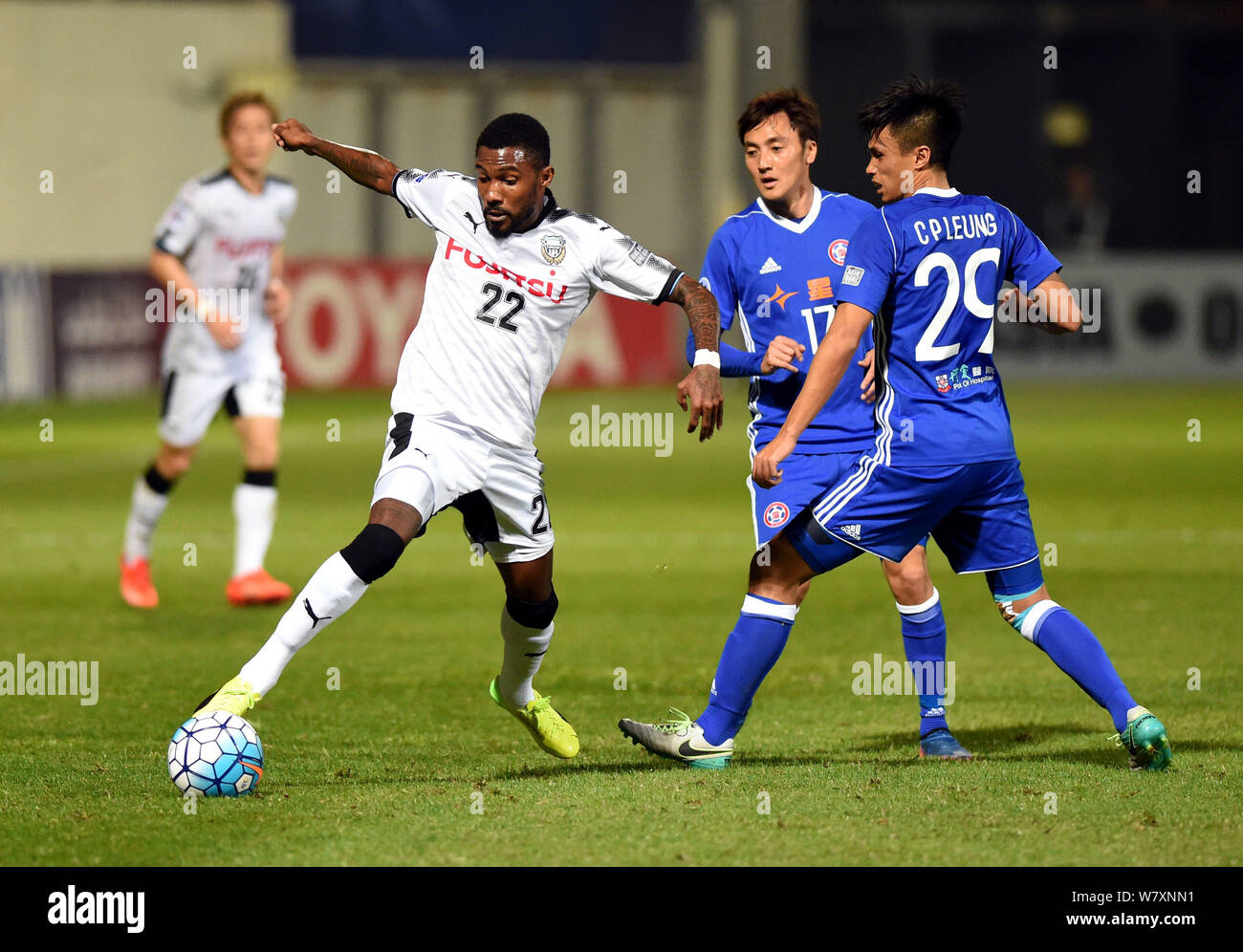 Rhayner of Japan's Kawasaki Frontale, left, challenges Lee Hong Lim, center, and Leung Chun Pong of Hong Kong's Eastern Sports Club in a Group G match Stock Photo