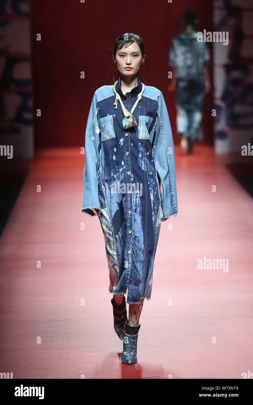 A model displays a new creation at the fashion show of CHENWEN Studio ...