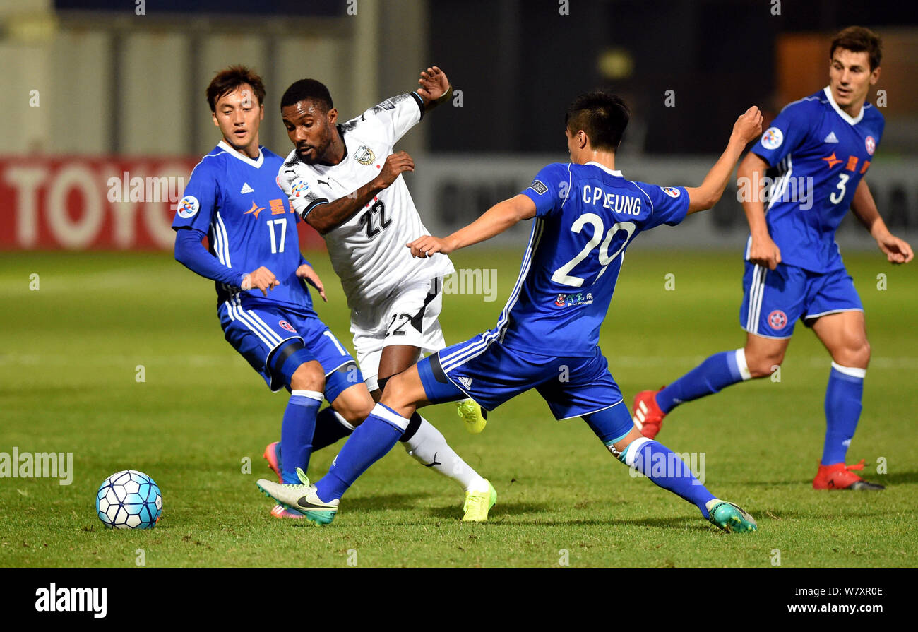 Rhayner of Japan's Kawasaki Frontale, second left, challenges Lee Hong Lim, left, and Leung Chun Pong of Hong Kong's Eastern Sports Club in a Group G Stock Photo
