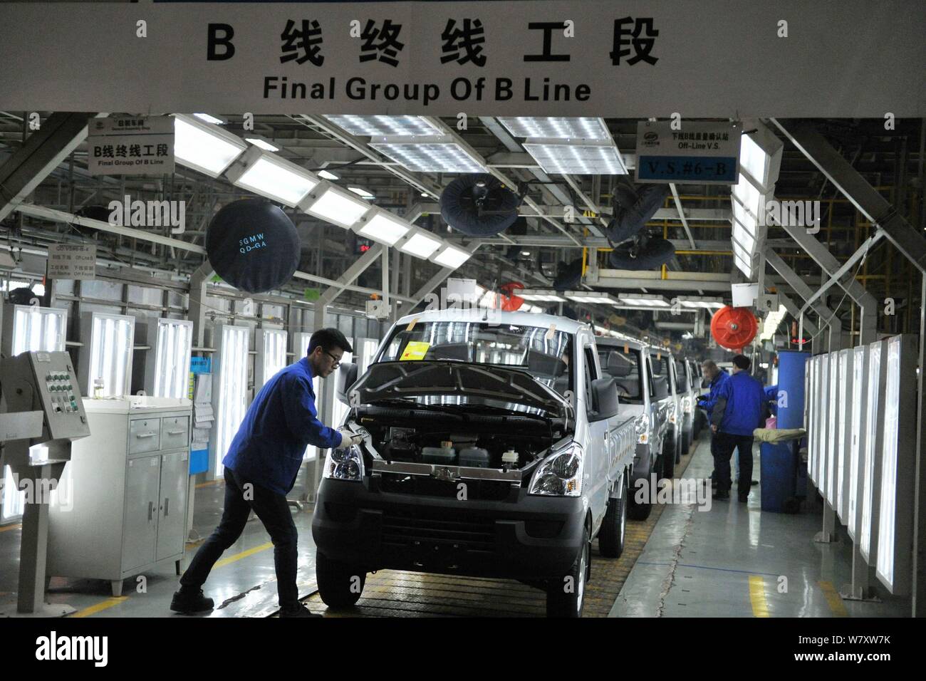 Chinese workers assemble cars on the assembly line at an auto plant of ...