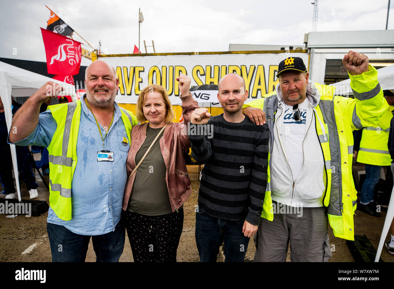(left to right) Harland and Wolff steel worker Joe Passmore, Irish Solidarity TDs Ruth Coppinger and Paul Murphy, and Harland and Wolff steel worker Barry Reid, standing at the gates of Harland and Wolff shipyard, Belfast, in support of the workers who are calling for the shipyard to be renationalised, as there has been deluge of support from donations of suncream and food to performances by local celebrities. Stock Photo