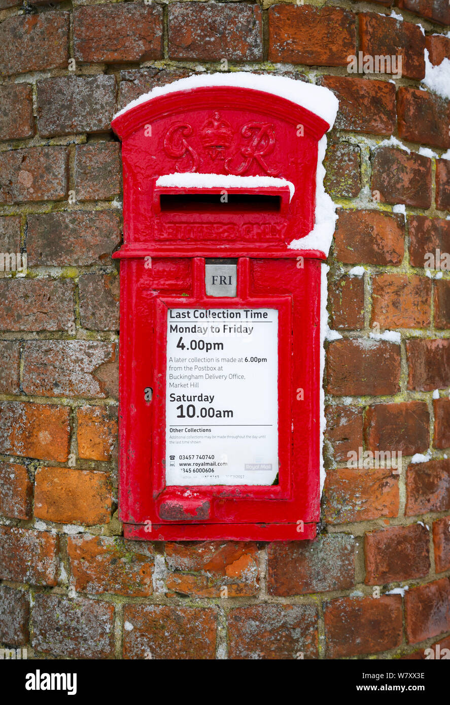 Buckingham, UK - February 01, 2019. A traditional British post box is set into a wall in Buckinghamshire. The post box dates from the reign of George Stock Photo