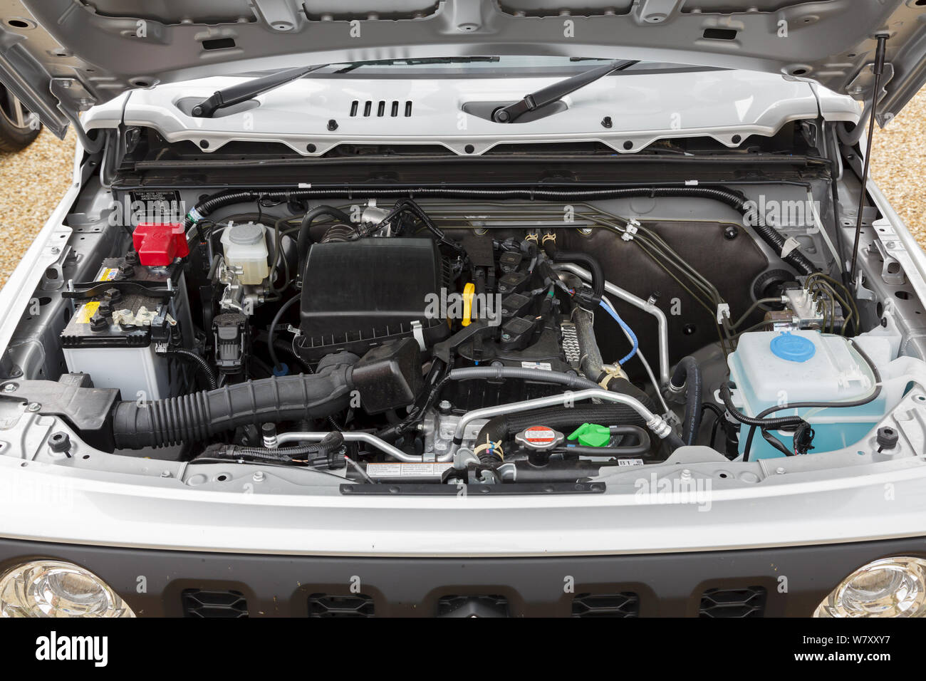 Buckingham, UK - May 16, 2019. Engine compartment underneath the hood or bonnet of a 2019 Suzuki Jimny. The engine is a 1.5L petrol. Stock Photo