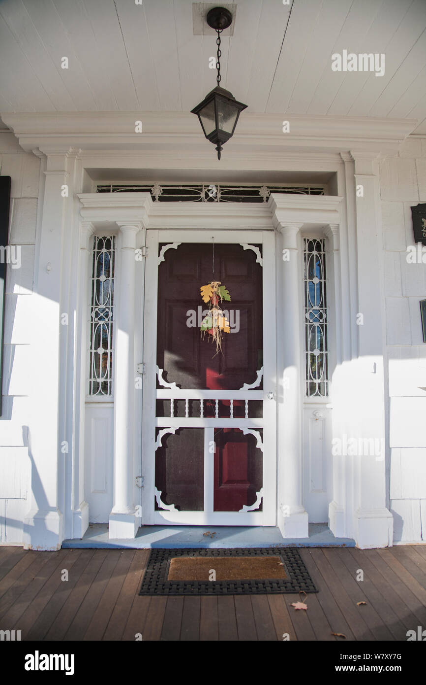 Vintage vertical autumn white front door, Freehold, Manalapan Township, farm house in New Jersey, USA, US, NJ America Pt Halloween decoration Stock Photo