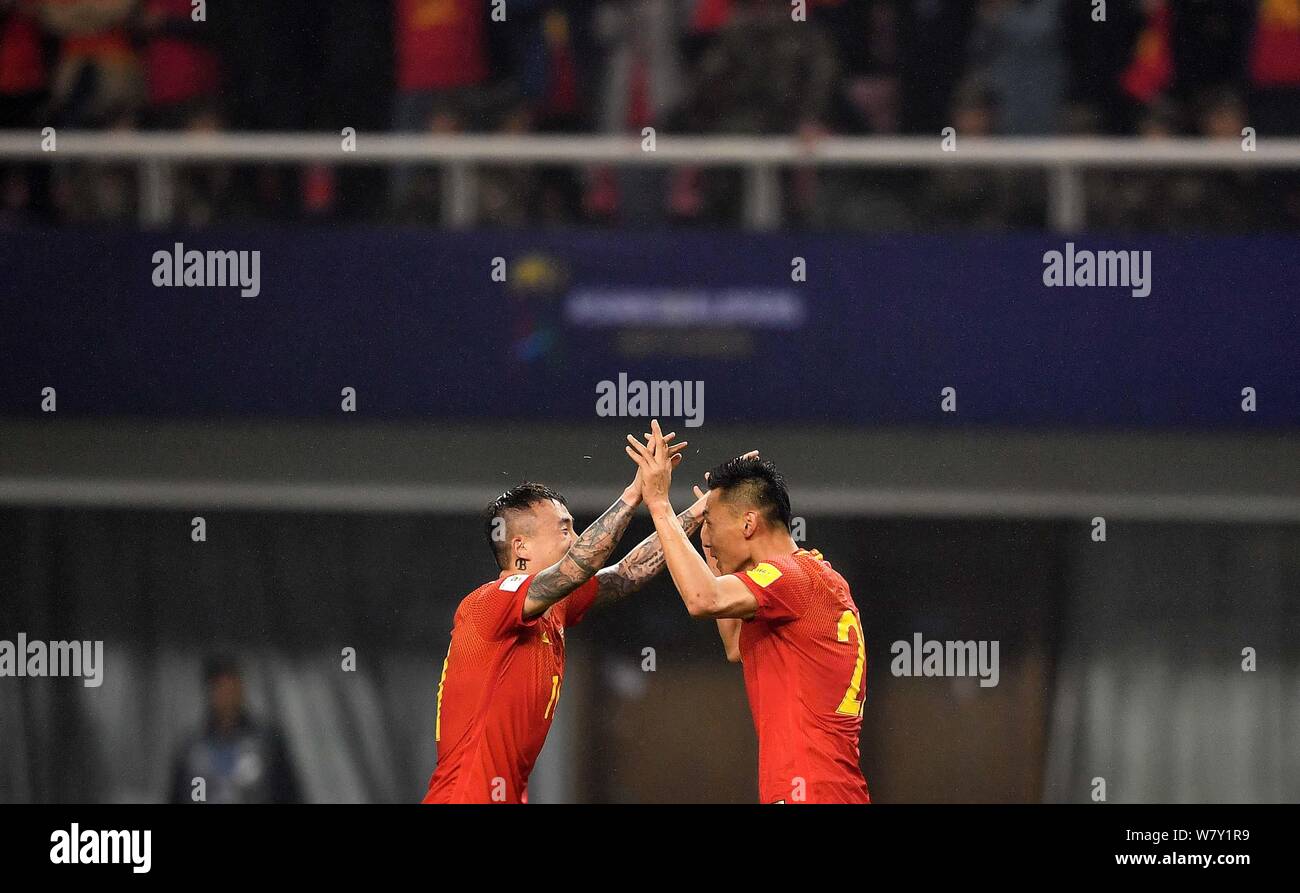 Yu Dabao, right, and Wang Yongpo of Chinese national men's football team celebrate after scoring a goal against South Korea in their Group A Round 6 m Stock Photo