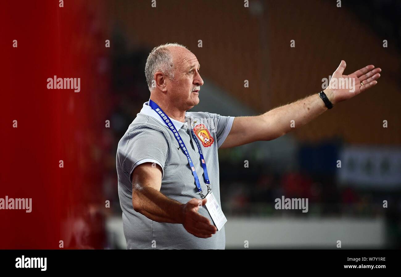 Head coach Luiz Felipe Scolari of Guangzhou Evergrande F.C. reacts as he watches his players competing against Beijing Guoan F.C. during their first r Stock Photo