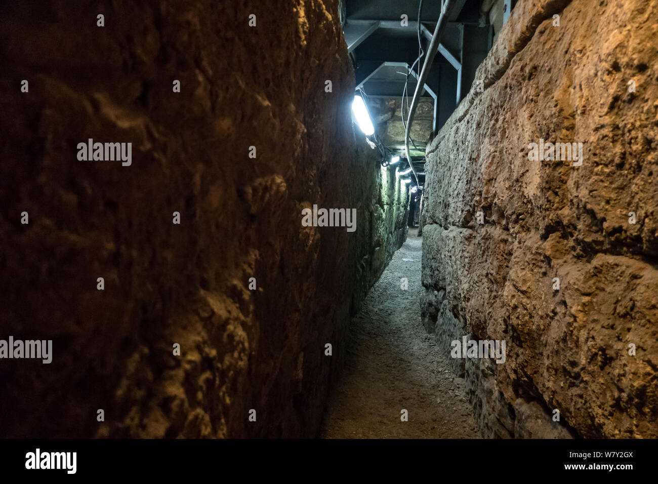 Jerusalem, Israel. 7th August, 2019. A dry tunnel beneath the Herodian Pilgrimage Road connects the City of David with what was the Temple Mount complex, now the Ophel Archaeological Park adjacent to the Western Wall. It is believed to have been dug as a drainage tunnel or hideout for city residents from attacking Romans in the Second Temple period. The City of David is speculated to be the original urban core of ancient Jerusalem. Religious Jews are in the midst of observing the 'Three Weeks' or 'Bein HaMetzarim', a period of mourning over the destruction of the first and second Jewish Temple Stock Photo