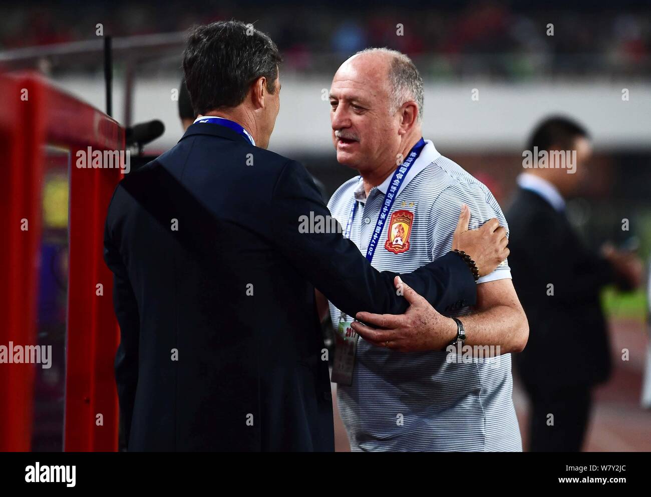 Head coach Luiz Felipe Scolari, right, of Guangzhou Evergrande F.C. greets a coach of Beijing Guoan F.C. during their first round match of the 2017 Ch Stock Photo