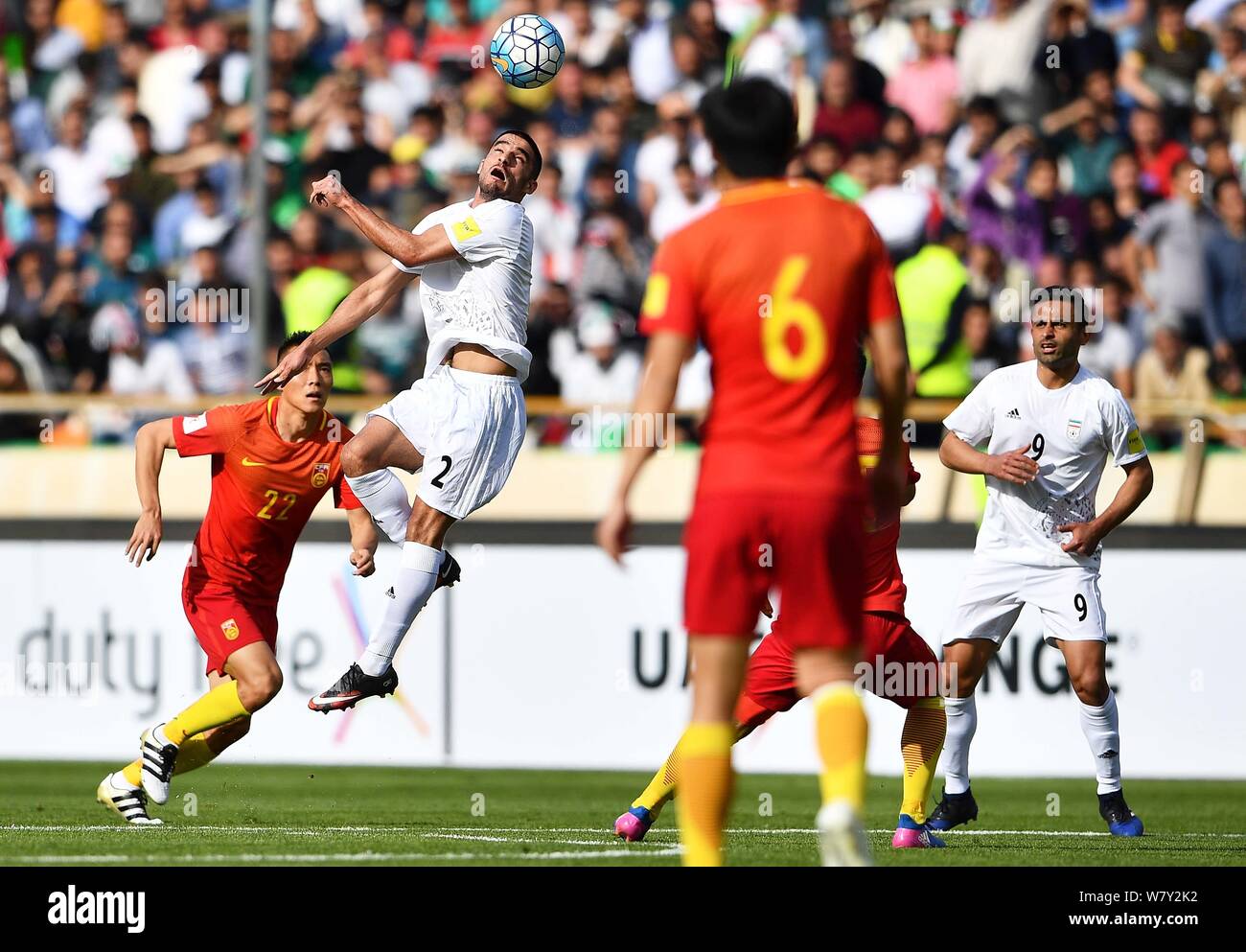 Milad Mohammadi of Iran, second left, heads the ball against players of China in their Group A Round 7 match during the FIFA World Cup 2018 Asian Qual Stock Photo