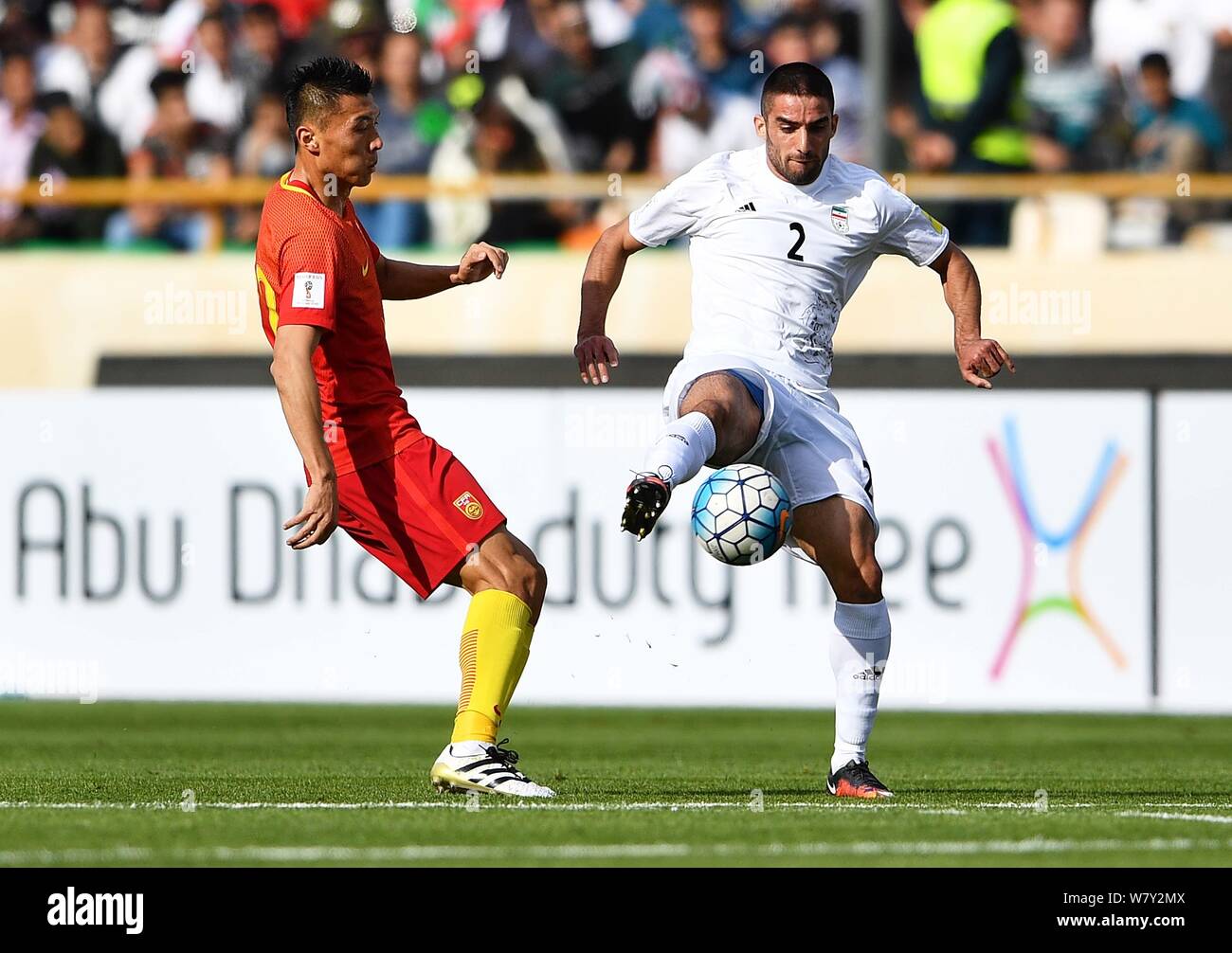 Milad Mohammadi of Iran, right, challenges Yu Dabao of China in their Group A Round 7 match during the FIFA World Cup 2018 Asian Qualifiers in Tehran, Stock Photo