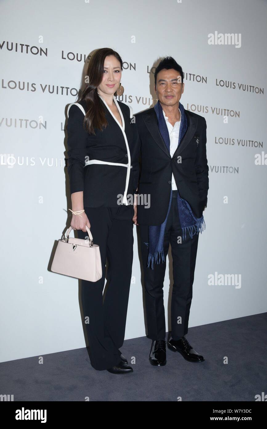 Hong Kong actor Simon Yam, right, and his model wife Qi qi pose as they  arrive at the opening party of a new Jimmy Choo boutique in Hong Kong,  China Stock Photo 