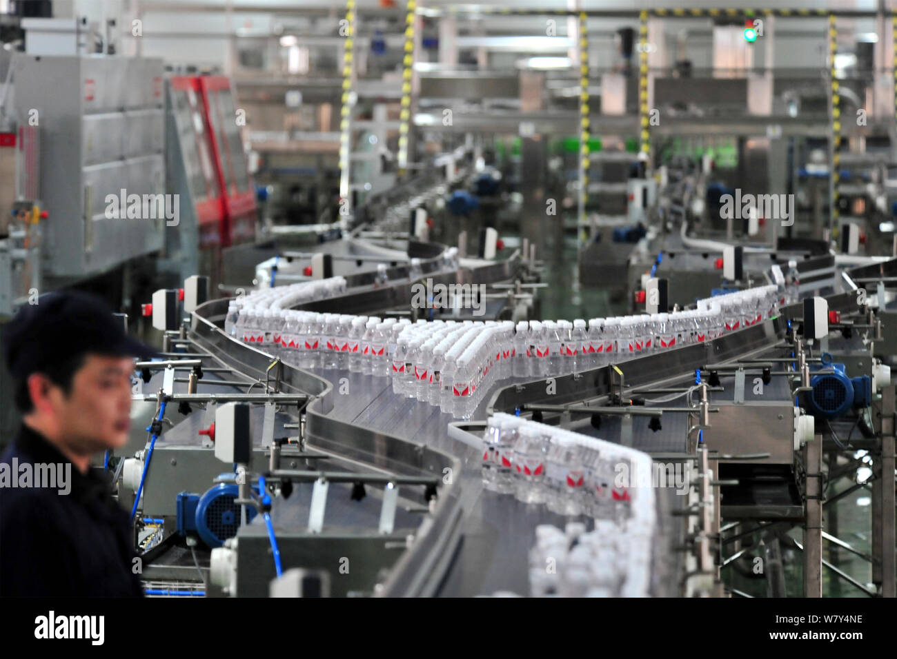 --FILE--A Chinese worker checks bottles of Wahaha purified water on the ...