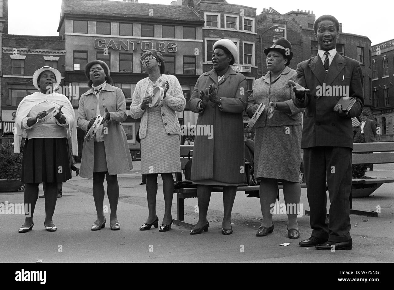 Black British church group evangelising, street preachers 1970s UK. An Afro-Caribbean Christian group singing and playing the tambourine in Derby town centre on a Sunday afternoon, 1970.  HOMER SYKES Stock Photo