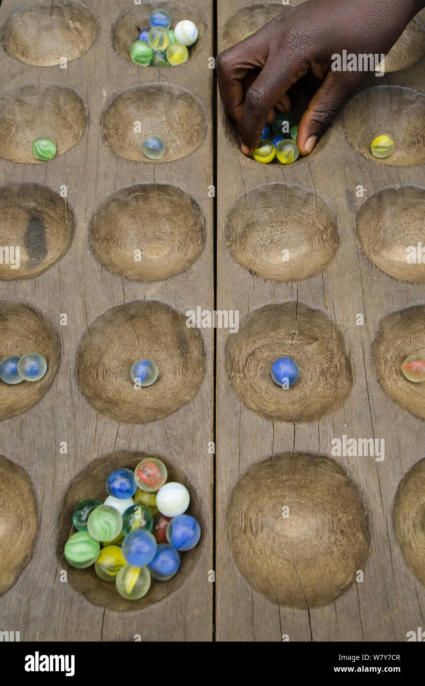 Traditional wooden board game with marbles. Mbomo Village, Odzala-Kokoua National Park, Republic of Congo (Congo-Brazzaville), Africa, May 2013. Stock Photo