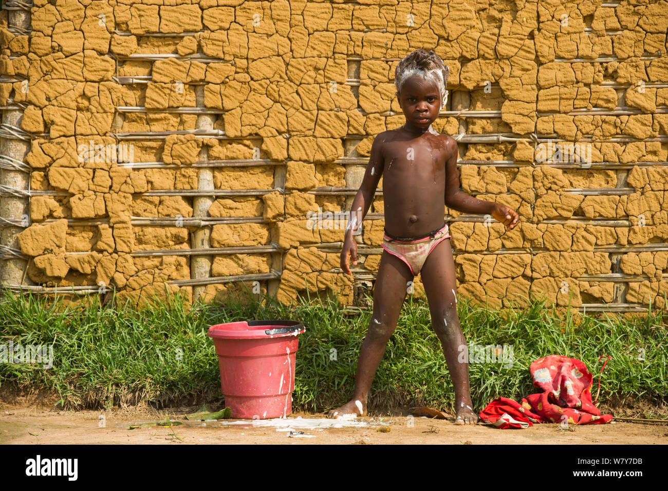 Local child washing in Mbomo Village, Odzala-Kokoua National Park, Republic of Congo (Congo-Brazzaville), Africa, May 2013. Stock Photo