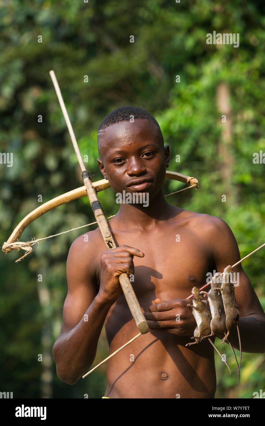 Boy with homemade crossbow used to shoot rats. Mbomo, Odzala-Kokoua National Park, Republic of Congo (Congo-Brazzaville), Africa, June 2013. Stock Photo