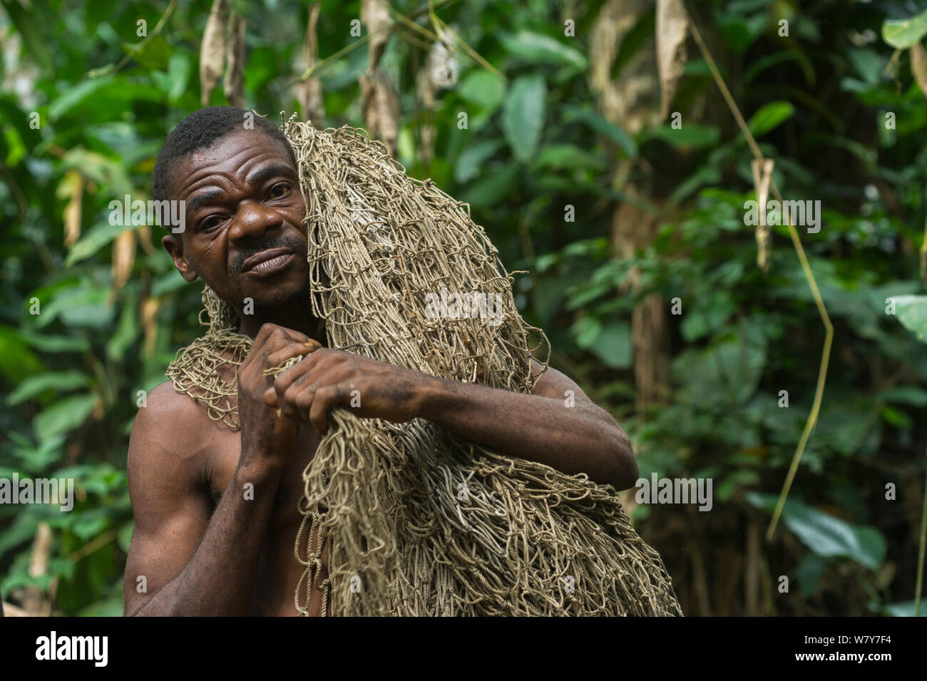 Ba&#39;Kola Pygmy man with traditional duiker hunting net. Mbomo, Odzala-Kokoua National Park, Republic of Congo (Congo-Brazzaville), Africa, June 2013. Stock Photo