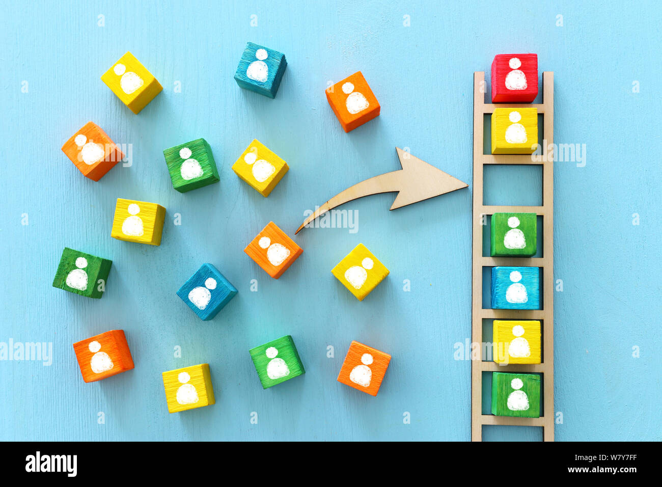 Business image of wooden ladder with people icons over blue table ...