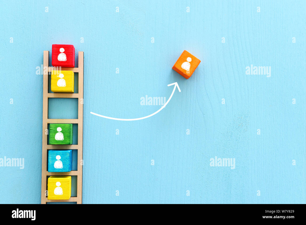 Business image of wooden ladder with people icons over blue table ...