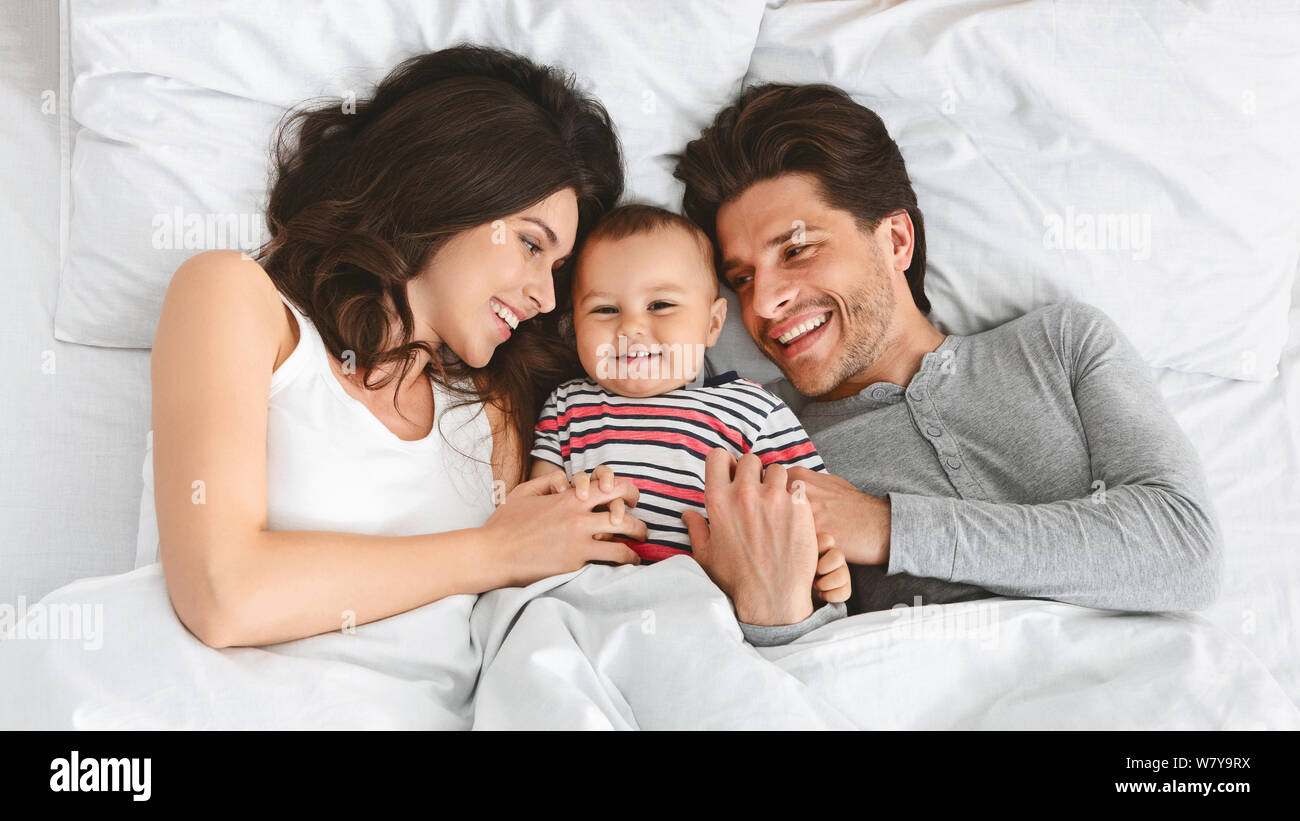 Cheerful Parents Having Fun With Their Baby Boy In Bed Stock Photo Alamy