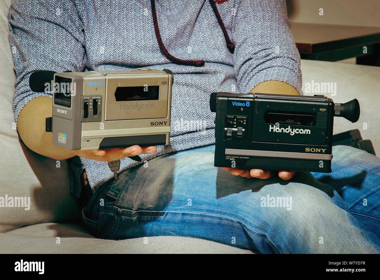 35-year-old Chinese videographer Mr. Gan shows world's first civil portable video camera Sony Handycam CCD-M8 he collected at home in Tianjin, China, Stock Photo